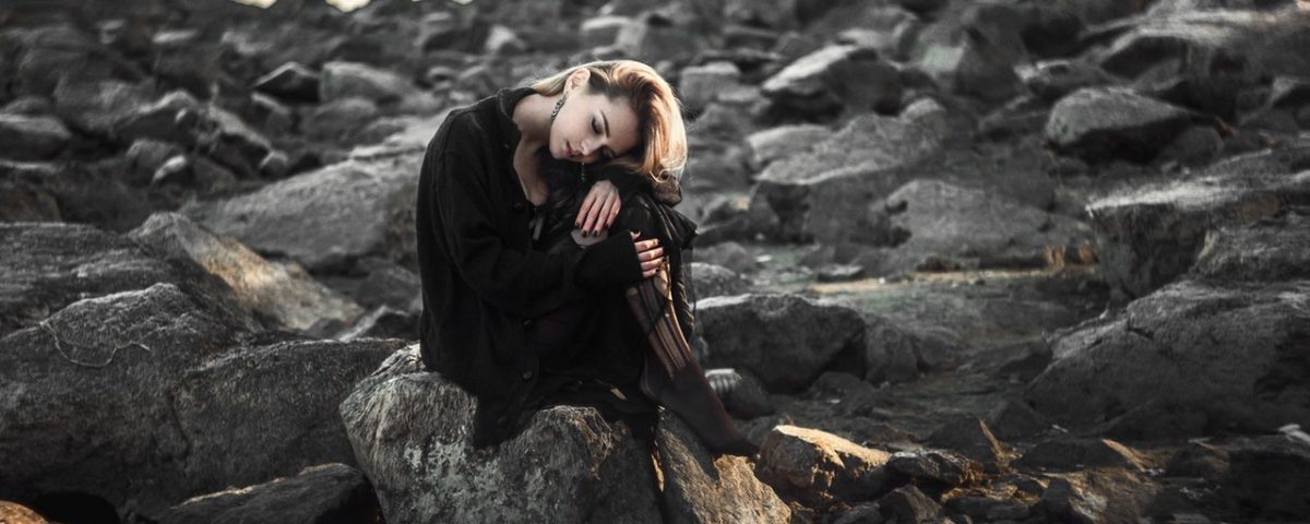 girl sitting on rocks