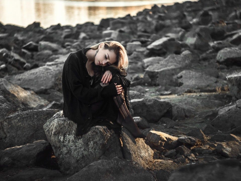 girl sitting on rocks