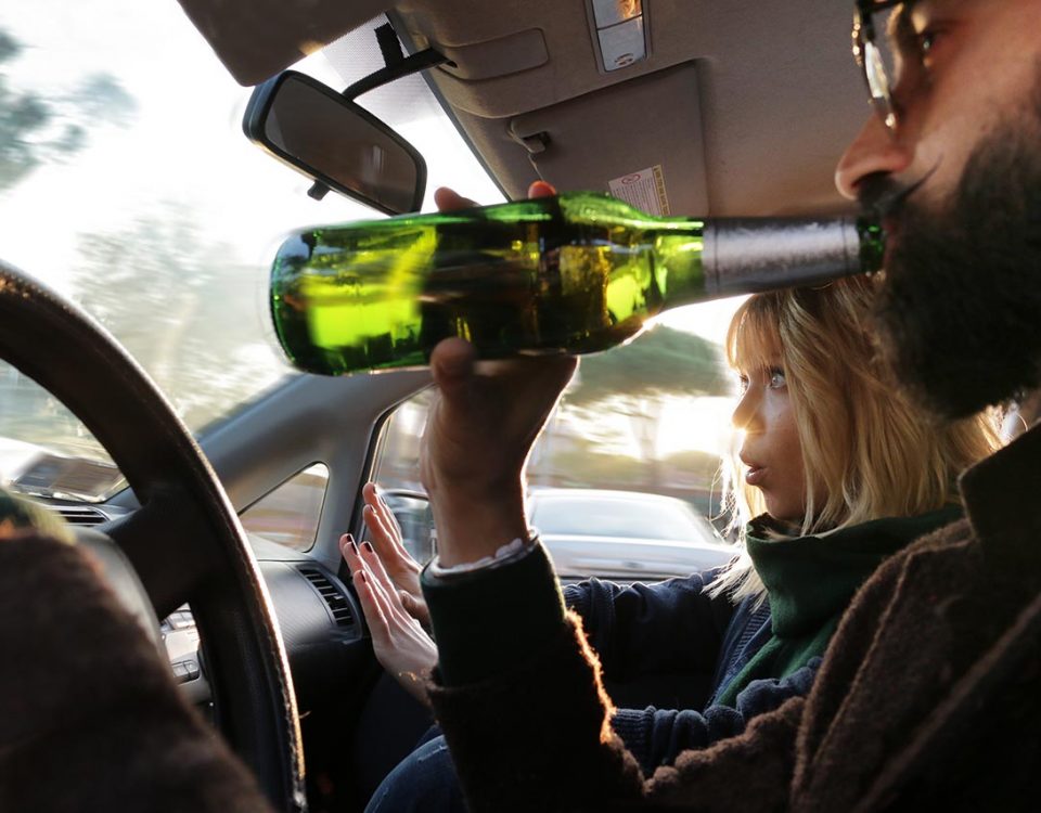 man drinking at wheel